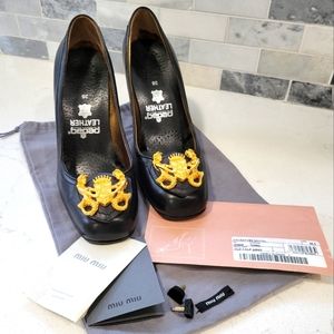 MIU MUI pumps with mermaid crest.